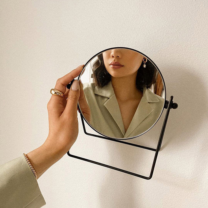 Woman holding mirror