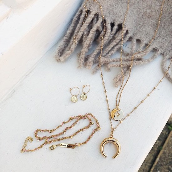 Kinoko marble earrings resting on marble